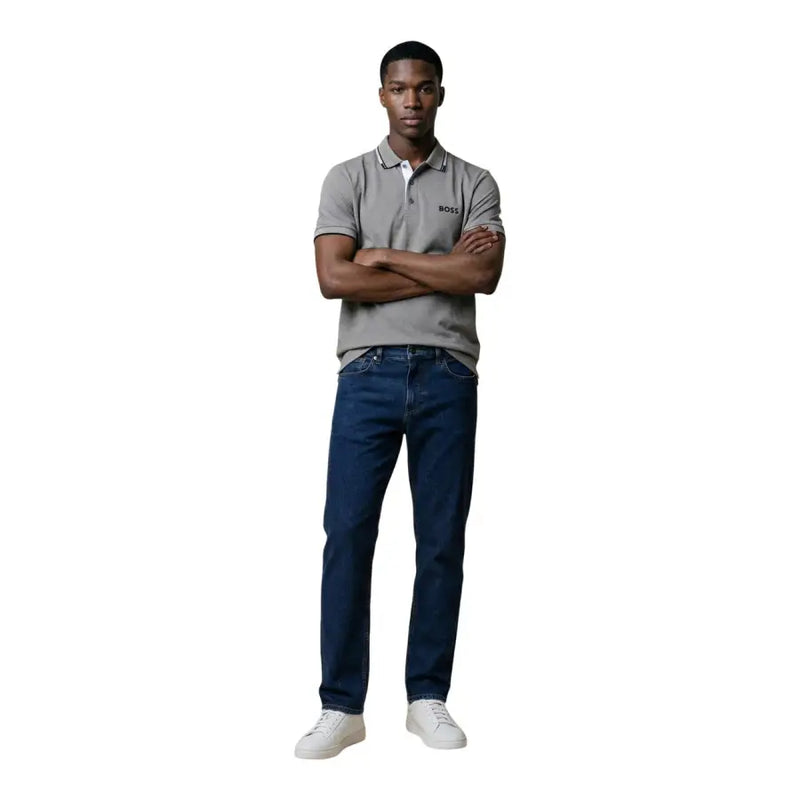 A man wearing a gray Hugo Boss cotton blend short sleeve polo shirt paired with dark blue jeans in size L