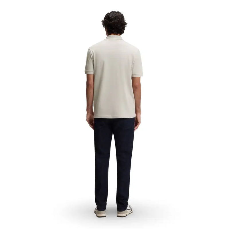 A man wearing a boss men polo shirt grey cotton zip neck short sleeve with a light beige classic collar and stitched seams