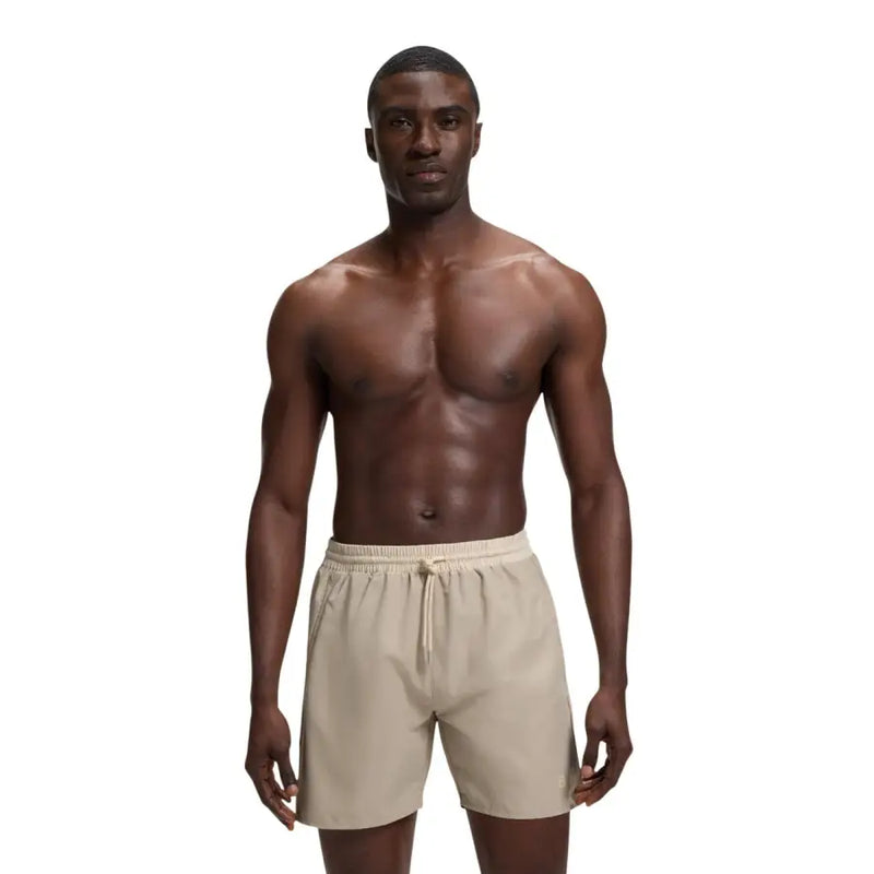 Beige Boss men swimwear athletic shorts with elastic waistband drawstring and subtle logo on lower right leg
