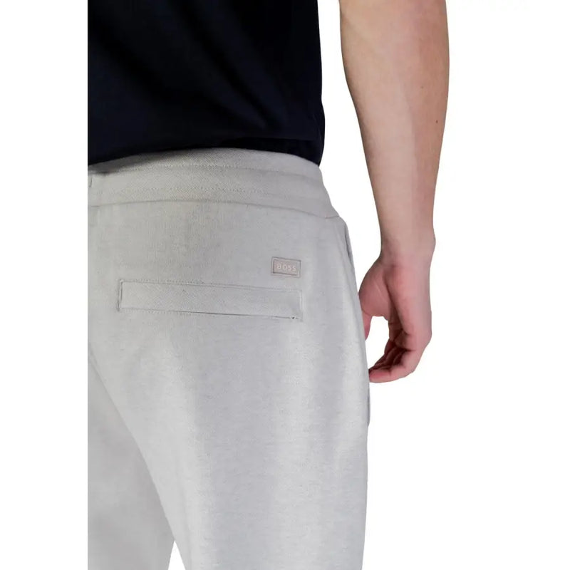 Back side of boss men trousers in light gray textured fabric joggers with a subtle woven label on the pocket