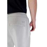 Back side of boss men trousers in light gray textured fabric joggers with a subtle woven label on the pocket