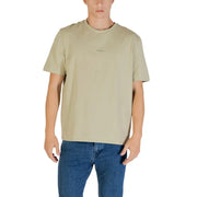 Men’s light olive green short-sleeve crewneck T-shirt paired with blue jeans