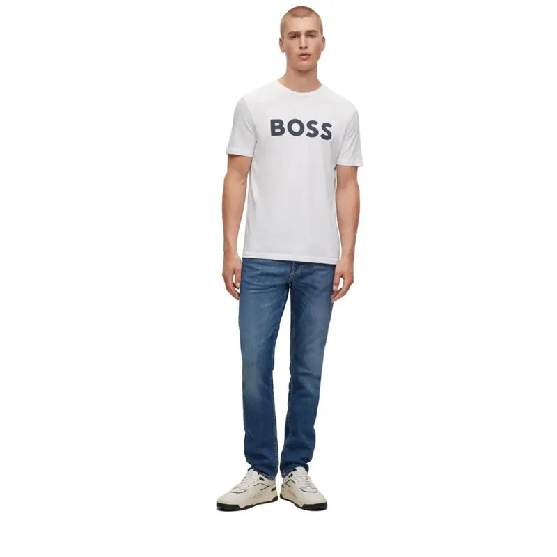 Man modeling Boss Men White Logo Print Round Neck Cotton T Shirt with blue jeans and white sneakers