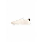 White leather low-top sneaker with black accents and logo.