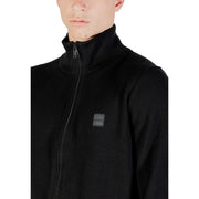 Boss wool turtleneck sweater for men in black with ribbed collar and subtle brand patch, front view