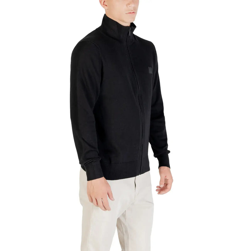 Boss wool turtleneck sweater for men in black with subtle logo patch on chest, front view
