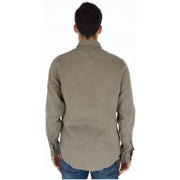 A men’s khaki long-sleeved button-up shirt with classic collar and cuffs by Brian Brome, made of green linen
