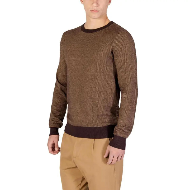 Brown textured sweater with ribbed cuffs and hem, likely made of cotton or polyester blend.