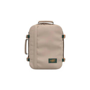 Beige Cabin Zero carry-on backpack with green accents and tan leather handles made of durable polyester