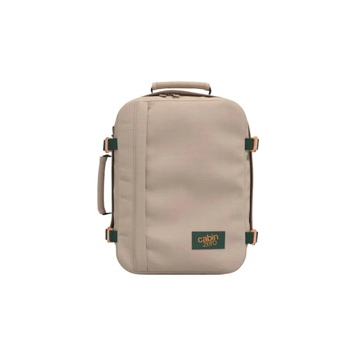 Beige Cabin Zero carry-on backpack with green accents and tan leather handles made of durable polyester
