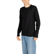 Black textured sweater with a diamond pattern, likely made of cotton or wool.