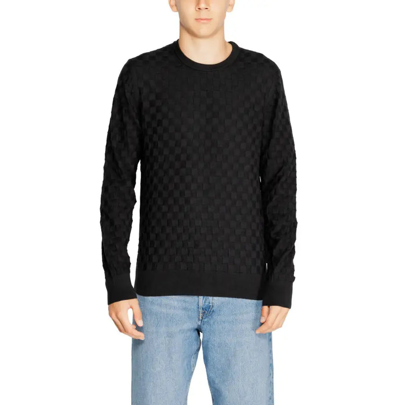Black quilted sweater with a textured pattern and crew neck.