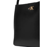 Calvin Klein black leather tote bag with shoulder strap featuring a gold-tone ck logo emblem