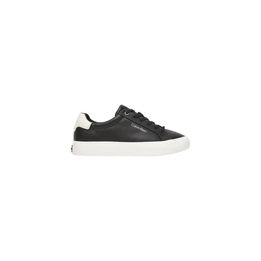Calvin klein black leather slip on sneakers for women showing low-top design with white rubber sole and heel tab