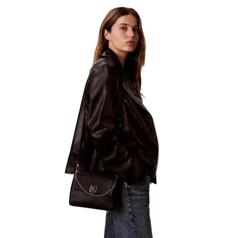 Calvin Klein black polyurethane leather crossbody handbag with silver chain shoulder strap and logo clasp