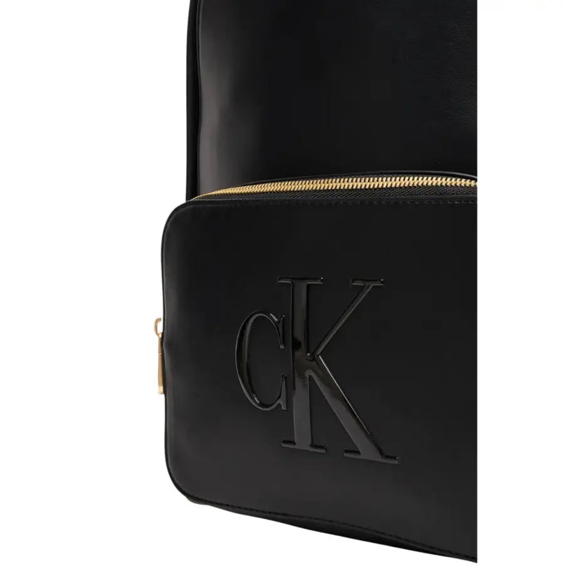 Calvin Klein black rucksack with glossy finish and gold-tone zipper featuring multiple zip pockets