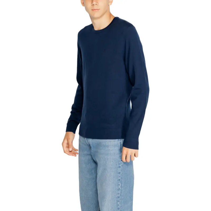 Navy blue wool long-sleeved round neck sweater for men by Calvin Klein ideal for formal and casual wear