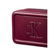 Burgundy leather calvin klein toiletry bag with embossed ck logo and interior pockets for organized storage