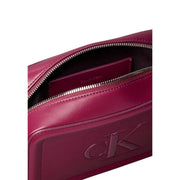 Calvin Klein burgundy leather crossbody bag with subtle embossed logo and silver-toned zipper with interior pockets