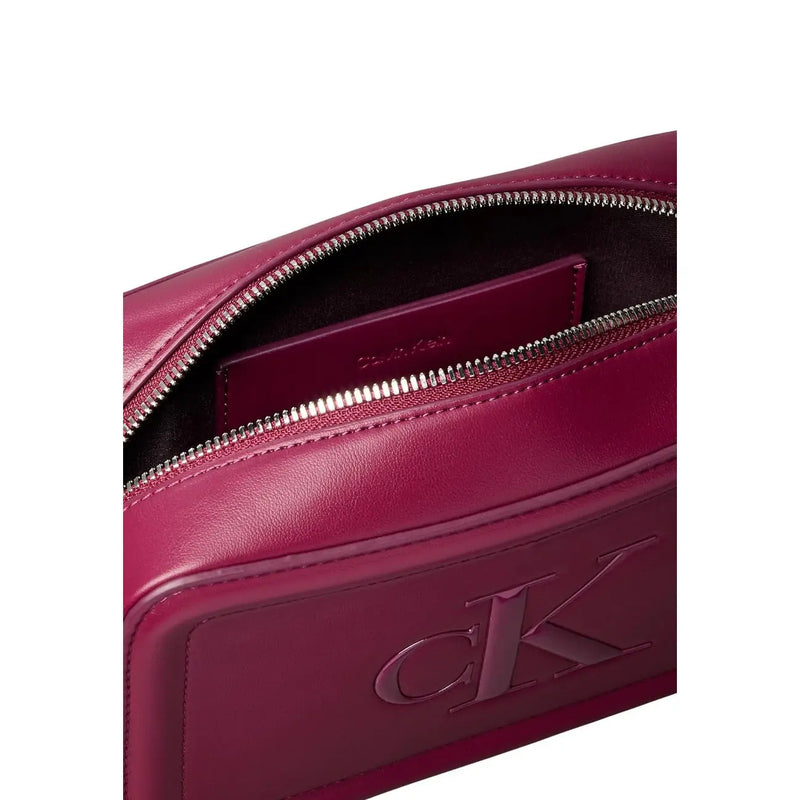 Calvin Klein burgundy leather crossbody bag with subtle embossed logo and silver-toned zipper with interior pockets