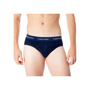 Navy blue calvin klein boys briefs with white logo trim made of cotton elastane blend for comfortable wear