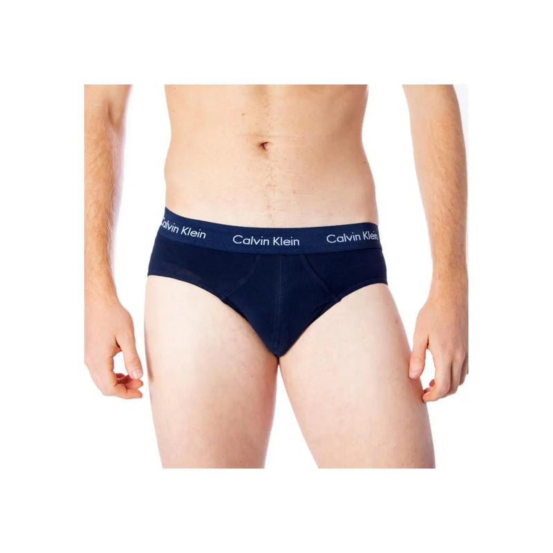 Navy blue calvin klein boys briefs with white logo trim made of cotton elastane blend for comfortable wear
