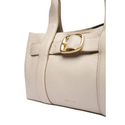 Cream-colored leather handbag with gold-tone buckle and structured design, contrasted with Calvin Klein grey polyurethane handbag