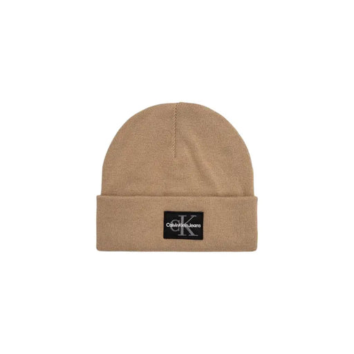 Beige calvin klein beanie with logo patch.