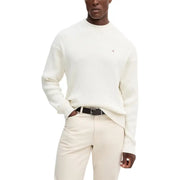 Cream-colored crewneck sweater with a small embroidered logo on the left chest.