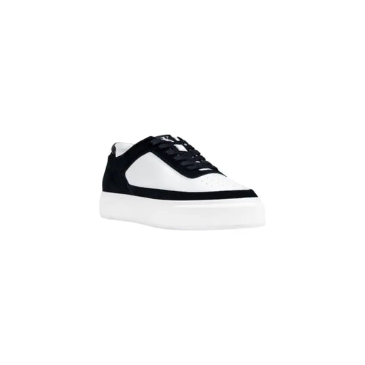 Black and white platform sneaker with lace-up design.