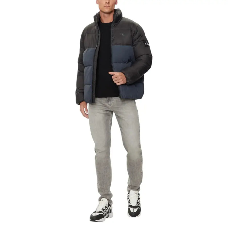 Navy blue puffer jacket with black accents and a quilted design, likely from north face.