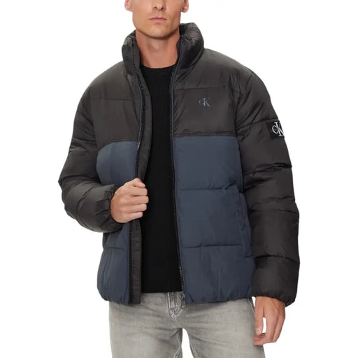 Black and navy blue puffer jacket with calvin klein logo on sleeve.