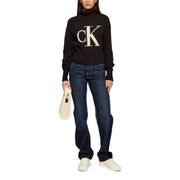 Calvin Klein Jeans black ribbed knit turtleneck sweater for women with large white ck logo on the chest
