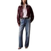 Calvin Klein Jeans Bordeaux women’s blazer in burgundy faux leather with a light pink contrasting collar and long zip front