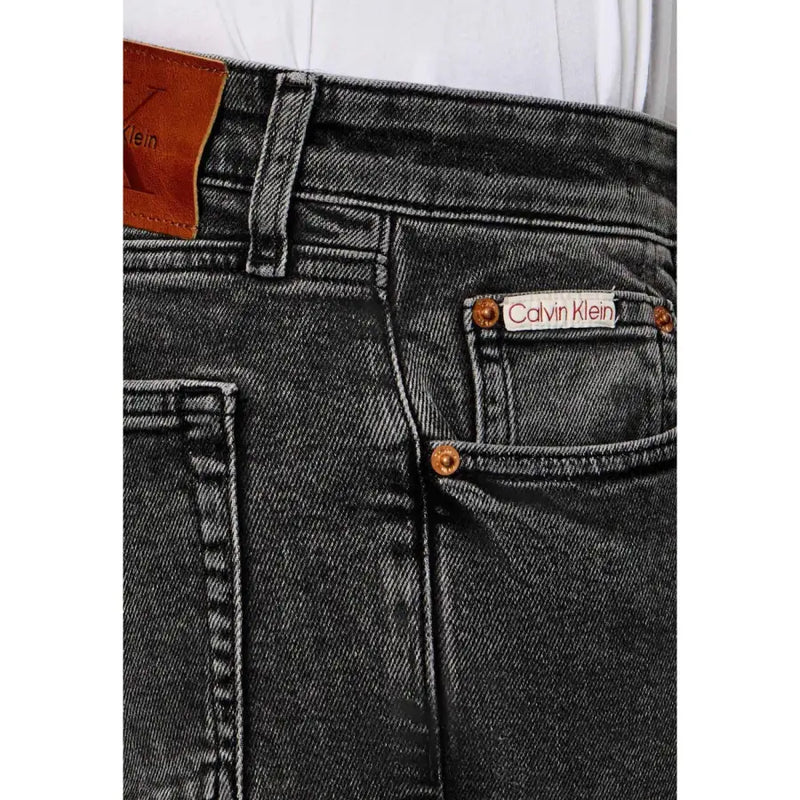 Calvin Klein Jeans men beige cotton classic fit jeans in black denim with faded wash brown leather patches and copper rivets back side