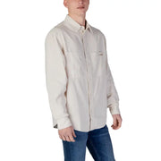A cream-colored beige cotton long-sleeved button-up shirt with chest pocket and Calvin Klein logo for spring summer