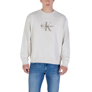 Men’s beige Calvin Klein crewneck sweatshirt paired with blue jeans for casual style