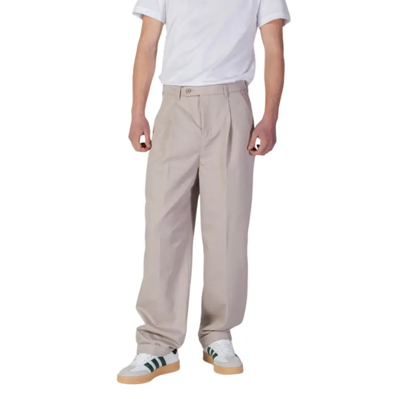Beige pleated chino pants with classic button closure and tapered legs from Calvin Klein Jeans men spring summer trousers