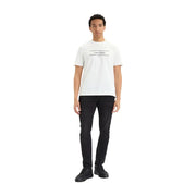 White calvin klein t-shirt with black logo and horizontal lines paired with black cotton denim slim jeans for men