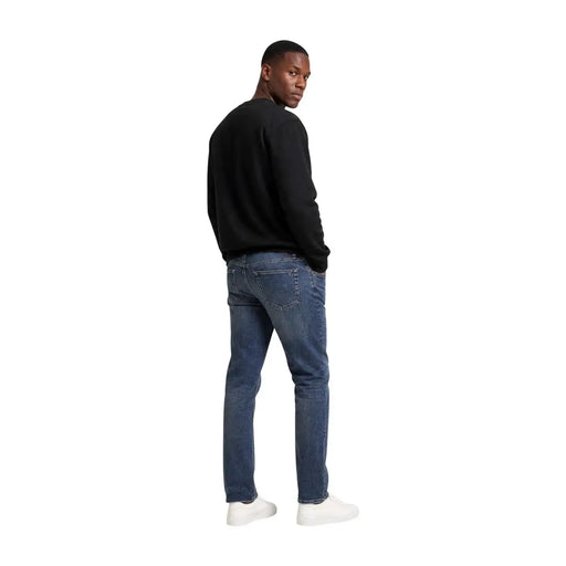 Dark-wash denim jeans with classic five-pocket design and subtle thigh fading paired with calvin klein men black cotton sweatshirt