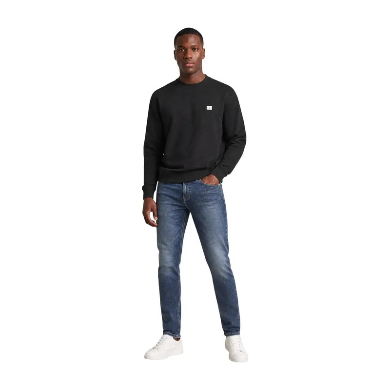 Calvin Klein Jeans men black cotton long-sleeved crewneck sweatshirt with a small white logo on the left chest