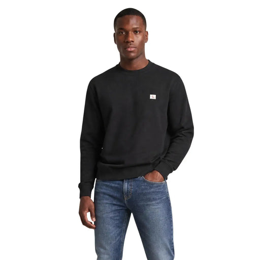 Calvin Klein jeans men black cotton crewneck sweatshirt with small white logo patch on left chest