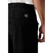 Calvin Klein Jeans men black cotton drawstring pants with sleek minimalist design and subtle logo patch on waistband