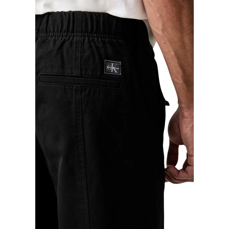 Calvin Klein Jeans men black cotton drawstring pants with sleek minimalist design and subtle logo patch on waistband