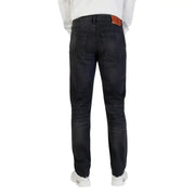 Coupe slim délavée foncée Calvin Klein Jean en coton pour homme avec fermeture éclair noire et étiquette de marque en cuir marron à la ceinture