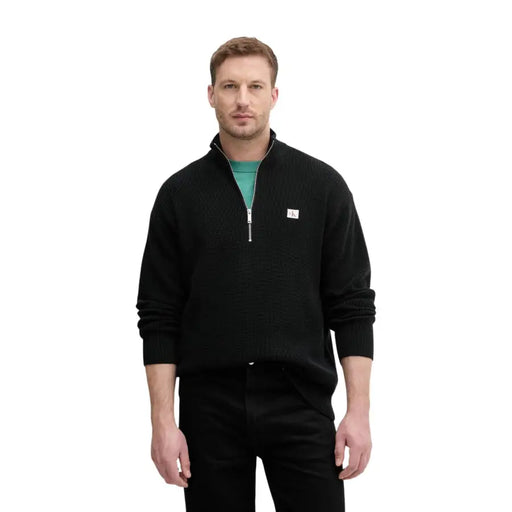 Calvin Klein Jeans Pull en maille de coton noir pour homme, avec demi-zip et petit logo blanc sur la poitrine