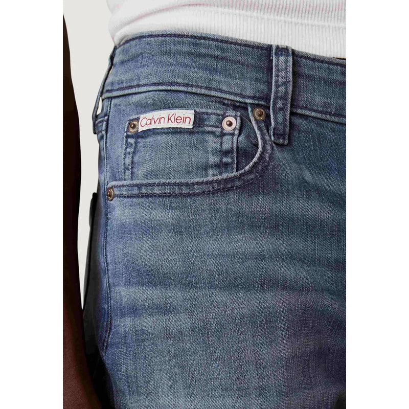 Back side of blue cotton denim slim fit jeans for men with calvin klein brand label on the back pocket