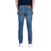 Calvin klein jeans men blue cotton denim jeans slim fit with classic fit and brown leather patch at the waistband back view