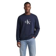 Navy blue Calvin Klein Jeans men cotton round neck sweatshirt with white CK logo on the chest