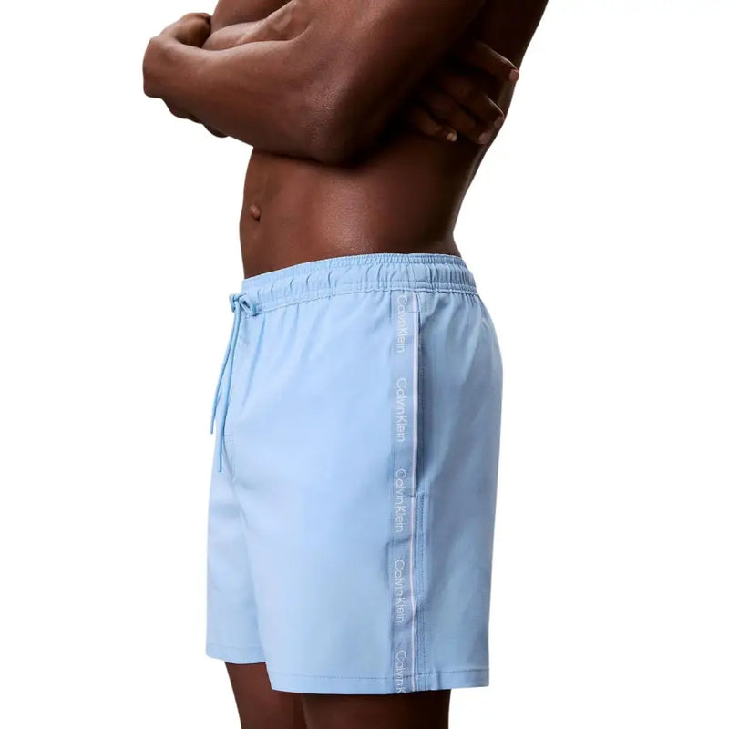 Light blue Calvin Klein Jeans men polyester drawstring swim trunks with vertical logo stripe on the side